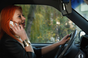 Girl Talking On Mobile Phone While Driving The Car. Teen safe driving Diemer Law blog.